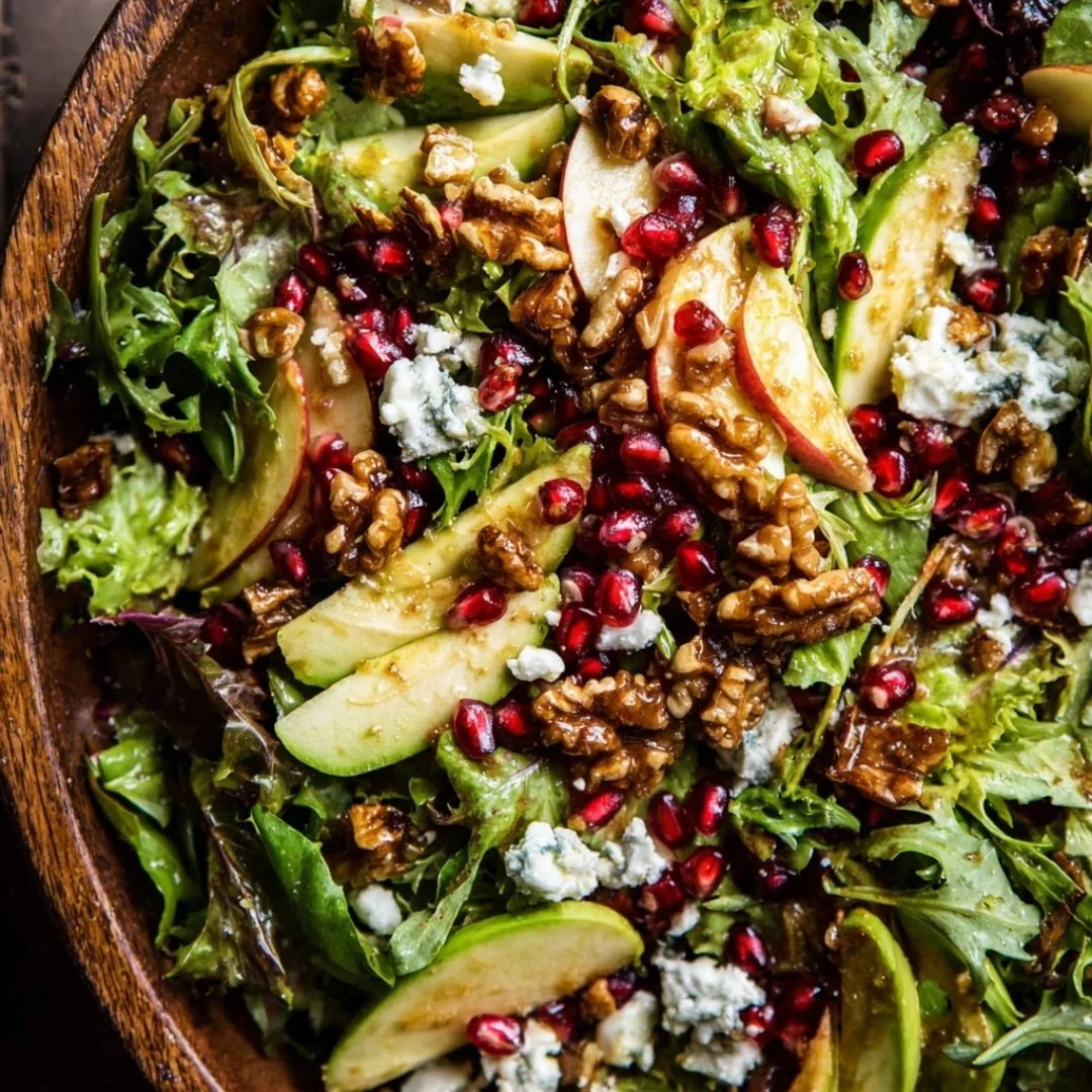 Colorful Christmas salad with honey mustard dressing served in a bowl