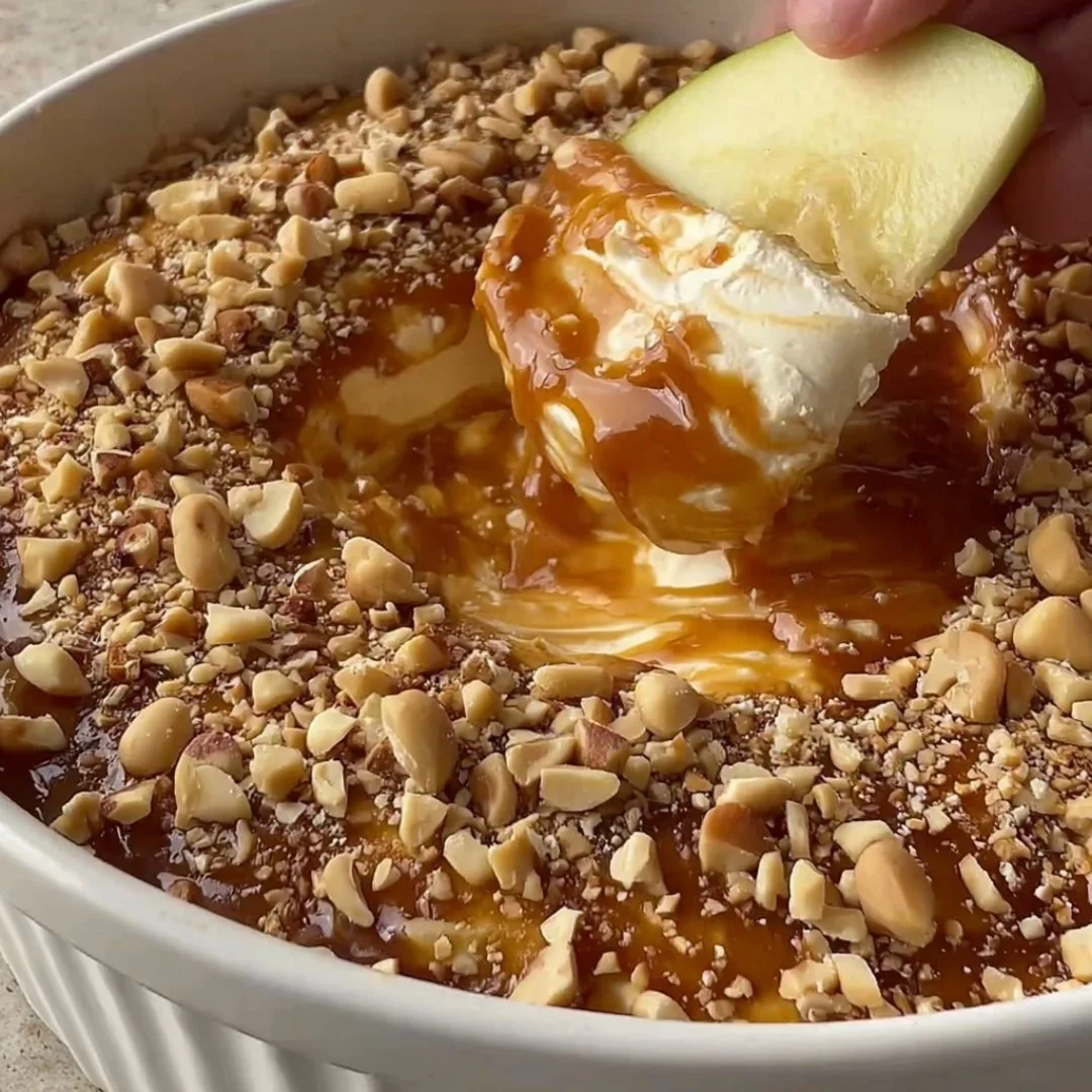 A bright, fizzy blue beverage with granulated salt crystals and a clear jar on a granite surface.